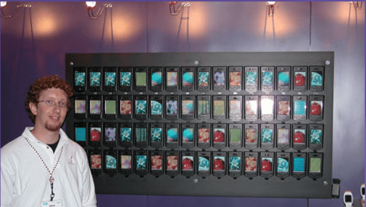 Craig next to display wall at tradeshow